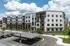 Beautiful modern apartment complex with spacious balconies, stunning architecture, and inviting green spaces.