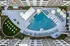 Luxurious aerial view of modern apartment complex featuring a stunning geometric pool surrounded by stylish loungers and chic umbrellas; perfect blend of relaxation and contemporary living.