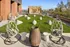 Chic rooftop lounge featuring stylish hanging chairs, modern patio seating, and vibrant green lawn with city views, perfect for relaxation and social gatherings.