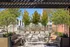 Inviting outdoor terrace with modern seating, lush greenery, and a stylish urban backdrop.