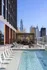 Luxurious rooftop pool with chic lounge chairs and stunning city skyline views.