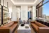 Luxurious modern living area with sleek leather sofas, elegant marble coffee table, and floor-to-ceiling windows offering stunning city views. Perfect blend of style and comfort.