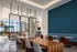 Modern lounge area with sleek wooden tables, comfortable seating, and expansive windows offering panoramic views.
