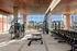 Luxurious state-of-the-art fitness center with panoramic city views, modern equipment, and spacious design.