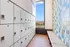 Modern locker room with secure storage, vibrant tiled walls, and scenic window view enhancing the space.