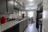 Charming kitchen with elegant gray cabinets, granite countertops, and cozy dining nook filled with natural light.
