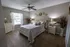 Cozy bedroom with a plush bed, elegant decor, and abundant natural light creating a tranquil retreat vibe.