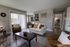 Inviting living room with elegant furniture, abundant natural light, and cozy neutral tones.