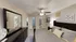 Inviting bedroom with plush carpeting, elegant dark wood furniture, and stylish ceiling fan, exuding comfort and charm.