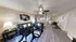 Contemporary living room with sleek leather sofas, stylish decor, and open-concept design leading into a chic dining area with modern flair.