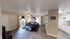Inviting open-concept living space with cozy seating, modern decor, and a bright, adjacent kitchen.