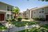 Charming apartment complex with lush green landscaping, inviting walkways, and modern exterior design.