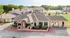 Charming apartment complex with stylish architecture, lush greenery, and ample parking, offering a welcoming community atmosphere.