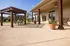 Inviting outdoor patio featuring a charming pergola, cozy seating, and lush greenery for a perfect relaxation spot.