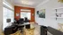 Bright and inviting home office featuring a modern desk setup, elegant lighting, and vibrant artwork on a stylish accent wall.