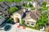Elegant apartment complex with Mediterranean-style architecture, lush greenery, and a vibrant central swimming pool area.