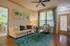 Charming living room with plush sofa, modern decor, and vibrant blue rug, offering a cozy and inviting atmosphere.
