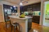 Elegant kitchen with modern appliances, granite countertops, and chic pendant lighting, offering a warm, inviting atmosphere.