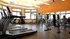 Bright and modern apartment gym featuring state-of-the-art treadmills, weight machines, and ample natural light.