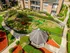 Charming apartment complex with lush landscaping, featuring a playful children's area and gazebo, perfect for family-friendly living.