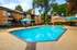 Inviting apartment complex with a stunning outdoor pool area, featuring comfortable seating and lush greenery.