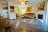 Inviting living room with elegant decor, featuring a cozy fireplace, warm lighting, and a charming seating area with stylish accents.