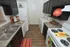 Charming galley kitchen with sleek dark cabinets, modern appliances, and stylish wood flooring. Includes a convenient in-unit laundry area.