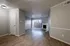 Spacious living room with elegant wood flooring, modern fireplace, and abundant natural light from large windows.