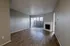 Elegant living room with warm wooden floors, a cozy fireplace, and large sliding glass doors leading to natural light.