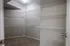Spacious walk-in closet with ample shelving and cozy carpet flooring, perfect for organizing your wardrobe.