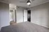 Modern bedroom featuring plush carpeting, contemporary ceiling fan, and convenient access to an en-suite bathroom.