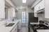 Modern galley kitchen with sleek appliances, ample counter space, and bright natural lighting.