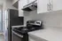 Sleek modern kitchen with stainless steel appliances, elegant white cabinets, and sparkling countertops.
