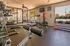 Modern fitness center with state-of-the-art gym equipment, bright natural lighting, and a serene outdoor view.