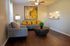 Chic living room with modern gray furniture, vibrant yellow pillows, and elegant decor, perfect for relaxation and entertaining.