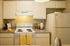Bright and inviting kitchen with modern appliances, sleek countertops, and chic yellow accents.