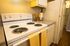 Cozy kitchen with modern stovetop, sleek countertops, and a warm, inviting ambiance.