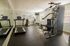 Inviting apartment gym featuring modern equipment, natural light, and sleek design for an inspiring workout experience.