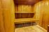 Inviting wooden sauna room featuring warm tones and built-in bench seating for relaxation.