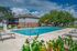 Inviting community pool surrounded by lush greenery and comfortable lounge chairs, perfect for relaxation in your new apartment home.