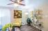 Inviting living room with modern decor, featuring a cozy yellow armchair, elegant glass shelving, and vibrant indoor plants under soft lighting.