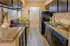 Modern kitchen with dark cabinetry, sleek appliances, and stylish backsplash creating a welcoming atmosphere.