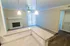 Modern living space with granite countertops, inviting fireplace, and abundant natural light.
