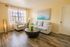 Bright and inviting living room with cozy seating, stylish decor, and beautiful wood flooring, perfect for relaxation and entertainment.