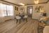 Bright and inviting living space with modern d&eacute;cor, large windows, and elegant wood flooring, perfect for comfortable living.