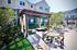 Charming outdoor patio featuring a shaded pergola, cozy seating area, and stylish dining set, perfect for relaxation and entertaining.