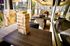Inviting outdoor area with elegant wicker furniture and a fun wooden block game, perfect for social gatherings in a stylish apartment complex.