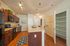 Modern kitchen with rich wooden cabinets, sleek countertops, and an inviting island, complemented by stylish lighting and spacious shelving.