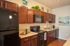 Elegant kitchen with rich wooden cabinets, modern appliances, and tasteful decor, perfect for culinary adventures.