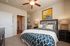 Elegant bedroom featuring stylish decor, a cozy bed with patterned linens, and ample lighting for a serene atmosphere.